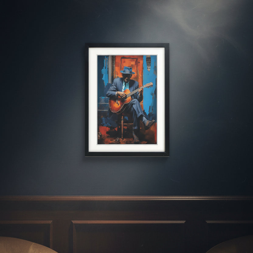 Framed wall art featuring a stylized painting of robert Johnson in a blue suit and hat playing an acoustic guitar, set against a vivid blue and orange background. The artwork is matted with a white border and enclosed in a black frame, shown on a plain white background.