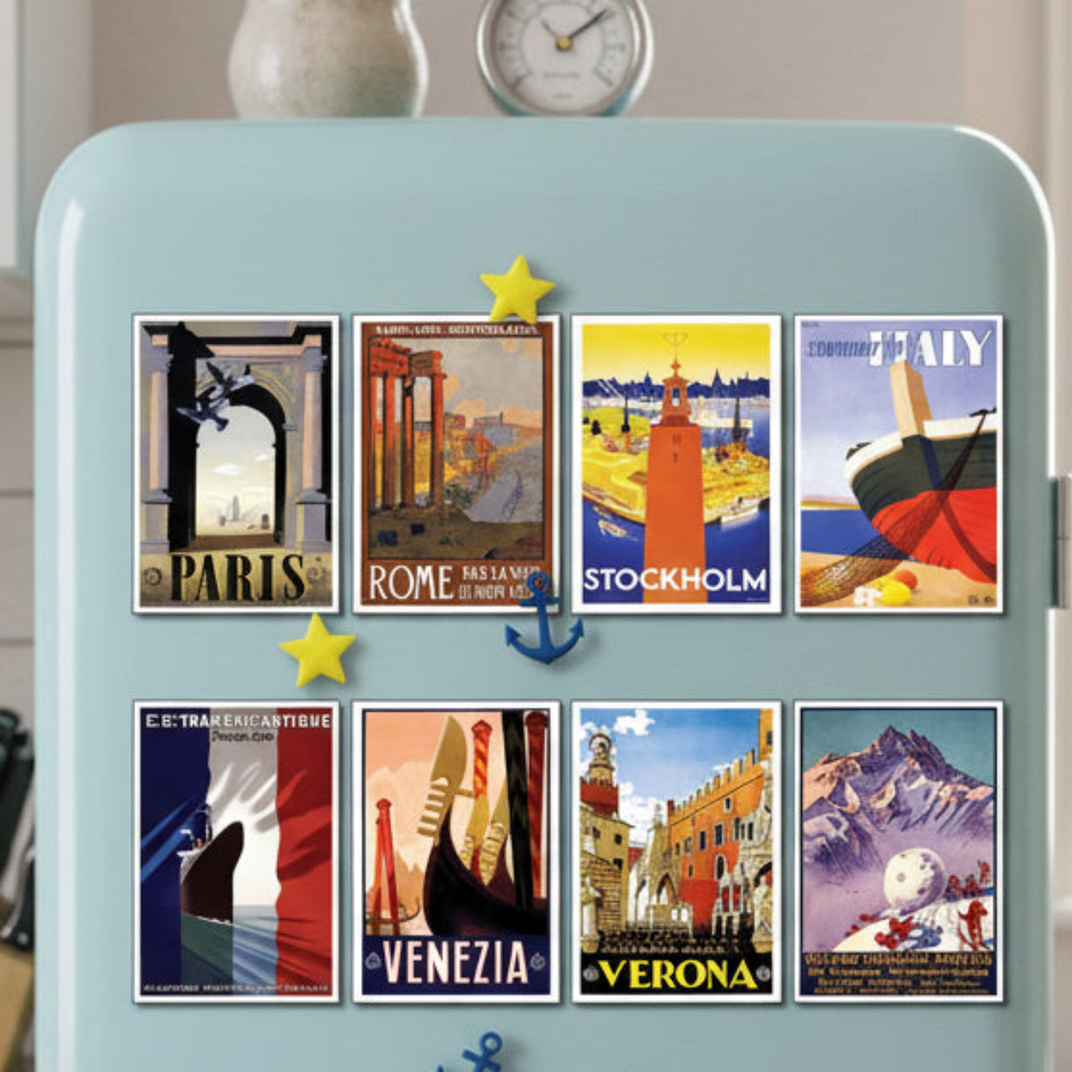 A set of eight vintage-style travel poster prints arranged in two rows on a gray background. The posters feature illustrated scenes and typography for Paris, Rome, Stockholm, Italy, C.