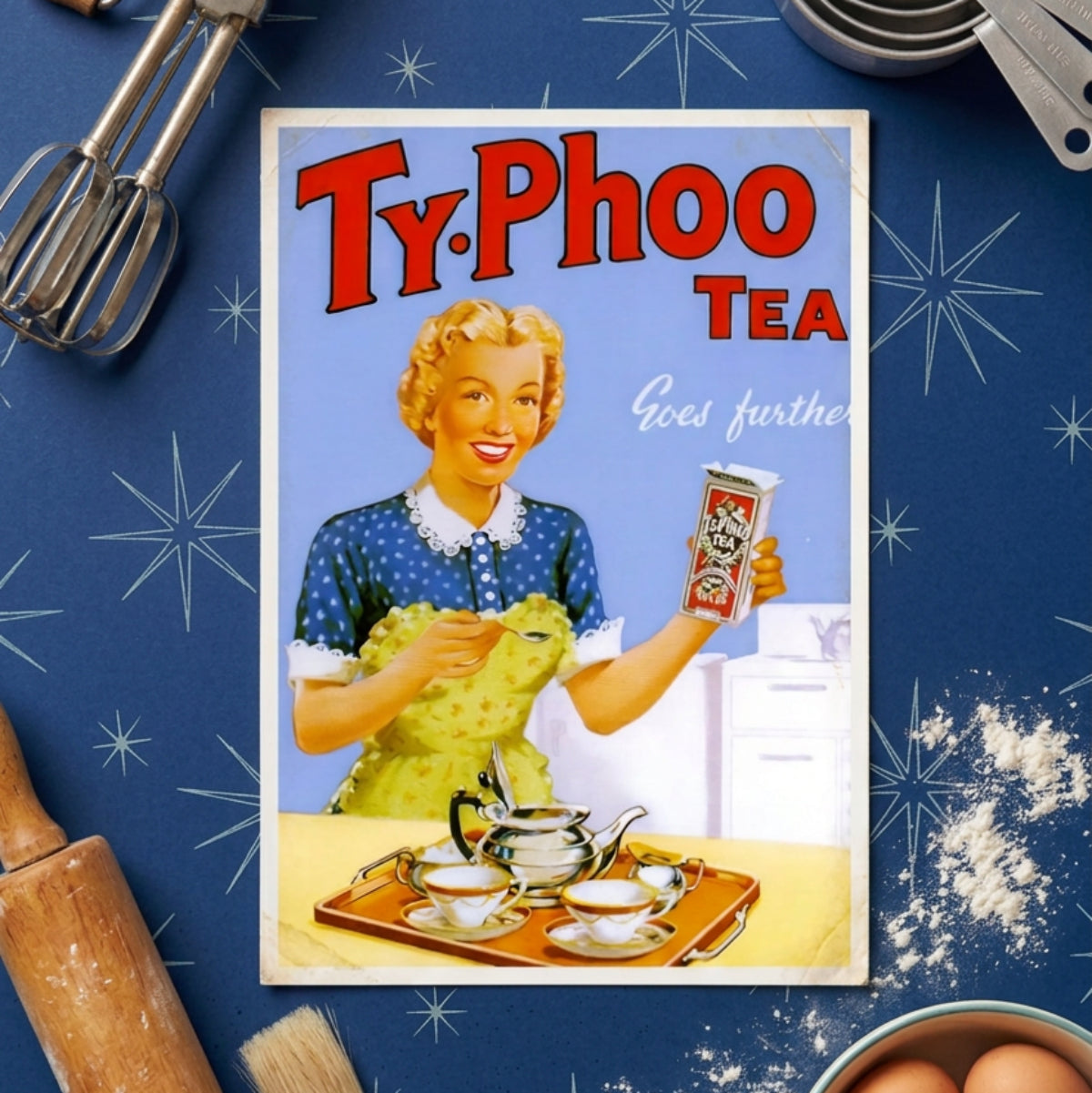 Vintage Ty. Phoo Tea advertisement poster featuring a woman in a blue polka-dot dress and yellow apron holding a tea packet, with a teapot and teacups on a tray in the foreground against a light blue background.
