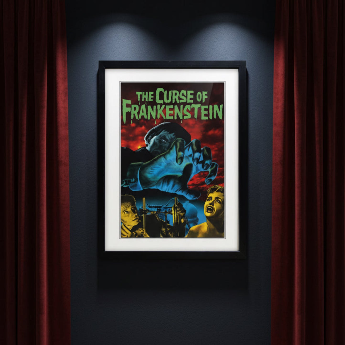 Framed vintage-style poster for 'The Curse of Frankenstein' with a black frame, white mat, and a dramatic illustration featuring a giant blue hand, red sky, and green title text.