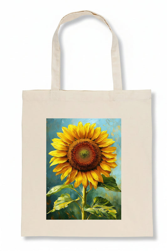 A natural canvas tote bag featuring a large, colorful printed painting of a sunflower on the front, set against a plain white background.