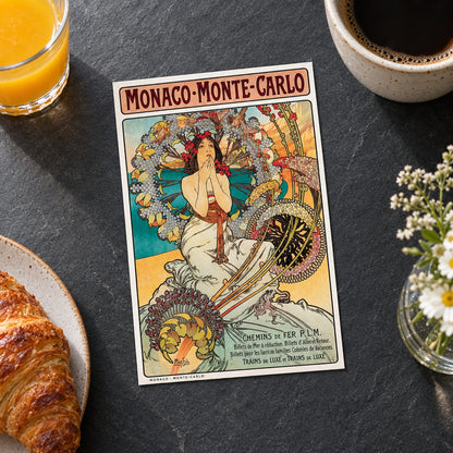 A vintage-style poster or print reading 'Monaco-Monte-Carlo' with an Art Nouveau illustration of a seated woman surrounded by ornate floral and architectural details, shown against a gray gradient background.