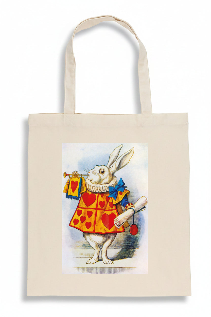 A natural canvas tote bag featuring a printed illustration of the White Rabbit in a red and yellow heart-patterned jacket, holding a scroll and a small bag, set against a plain white background.