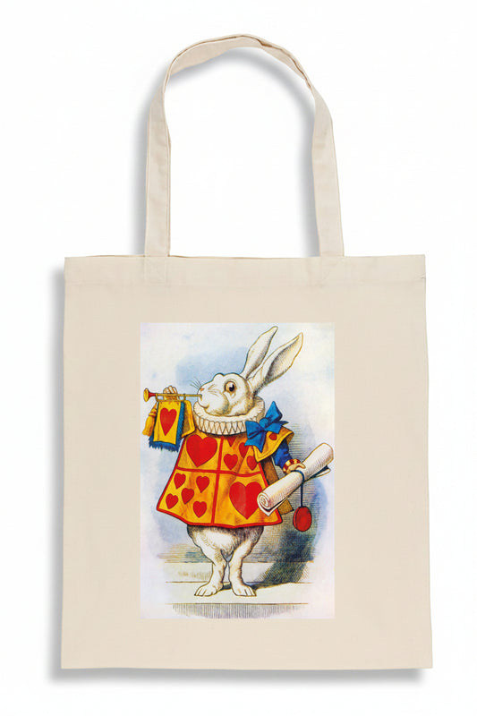 A natural canvas tote bag featuring a printed illustration of the White Rabbit in a red and yellow heart-patterned jacket, holding a scroll and a small bag, set against a plain white background.