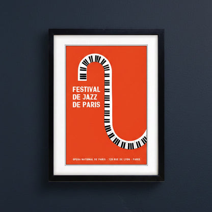 Framed poster print featuring a bold orange background with a stylized piano keyboard forming the letter S, alongside the text 'FESTIVAL DE JAZZ DE PARIS' in white. The print is matted in white and enclosed in a black frame, shown against a plain white background.