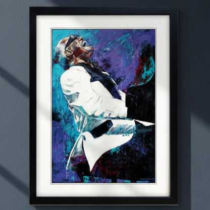 Framed wall art featuring an expressive, painterly portrait Ray Charles playing a piano, with bold blue, purple, black, and white brushstrokes. The artwork is presented in a black frame with a white mat against a dark blue wall.