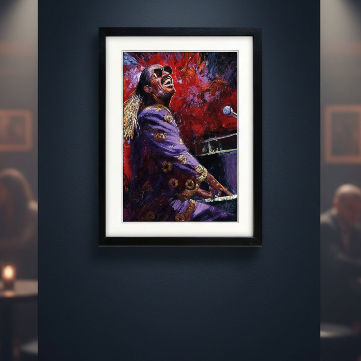 Framed canvas wall art featuring an expressive painting of Stevie Wonder in a purple outfit against a vivid red and blue background, shown in a black frame.
