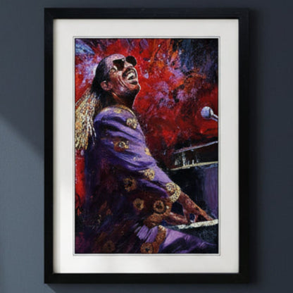 Framed canvas wall art featuring an expressive painting of Stevie Wonder in a purple outfit against a vivid red and blue background, shown in a black frame with white matting on a white background. The frame is mounted on a dark blue wall with natural lighting.