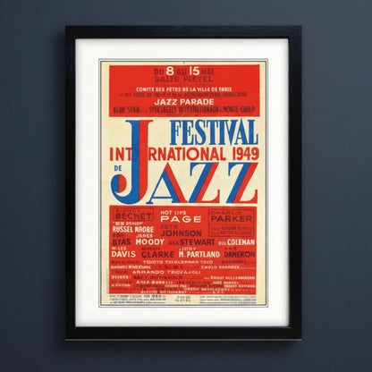 A framed vintage-style poster for the 1949 International Jazz Festival, featuring bold red, blue, and cream typography with a black frame and white mat.