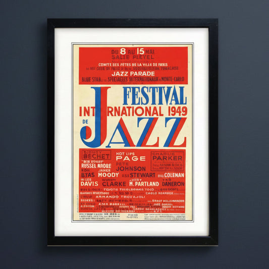 A framed vintage-style poster for the 1949 International Jazz Festival, featuring bold red, blue, and cream typography with a black frame and white mat.