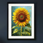 Framed canvas art print featuring a textured, impressionistic painting of a yellow sunflower with green leaves against a blue background, enclosed in a black frame with a white mat.