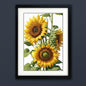 Framed botanical art print featuring three yellow sunflowers with green leaves on a white background, enclosed in a black frame with a white mat.