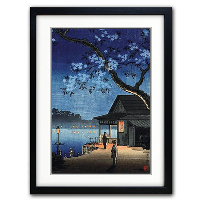 Framed Japanese style night scene art print with cherry blossoms shown against a plain white background.