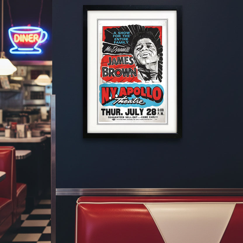 A framed vintage-style poster print featuring James Brown, with bold red, blue, black, and white typography and a black frame on a white background.