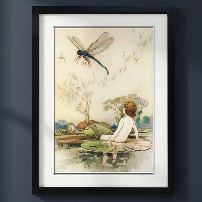 A framed art print featuring a vintage illustration of a child sitting on a lily pad beneath a large blue dragonfly, set in a black frame with a white mat.