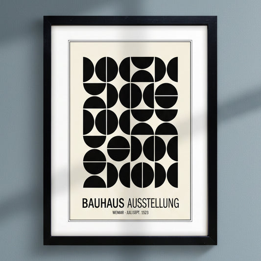 Bauhaus print hung on dark blue wall  natural sunlight 