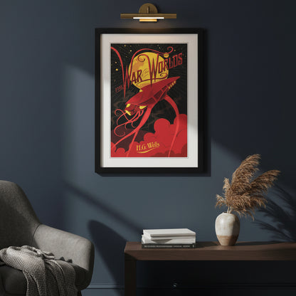 A framed art print of H.G. war of the worlds book cover print in a black frame on white wall