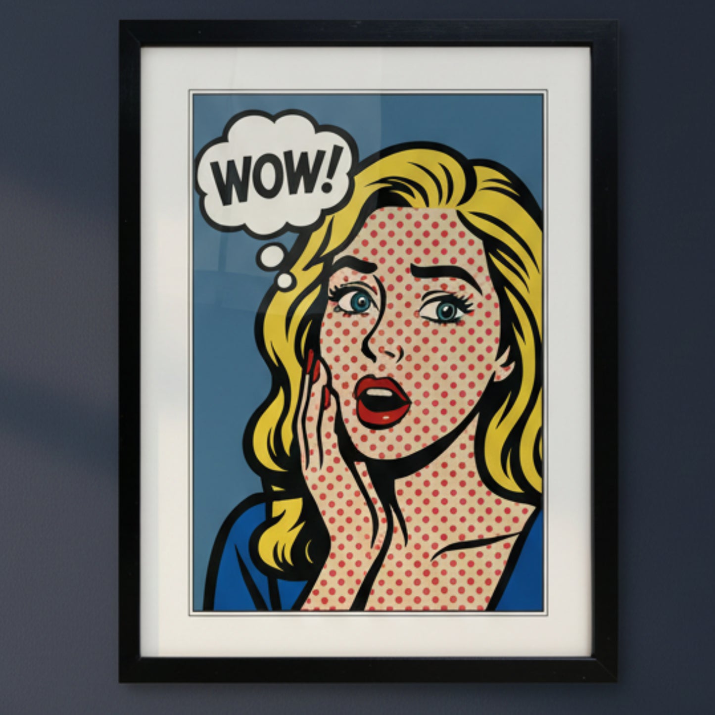 A framed pop-art print featuring a blonde woman with a halftone dot pattern, a speech bubble that says 'WOW!', and a red polka-dot background, shown in a black frame against a white wall.