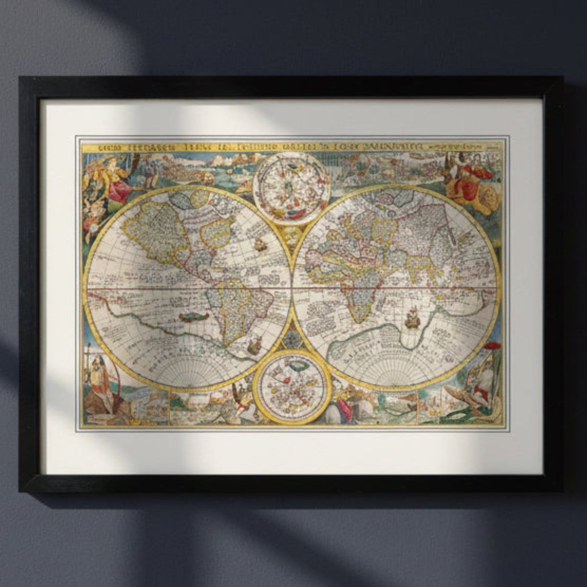 A framed vintage world map print with an ornate black frame and white mat, displayed against a dark gray wall with soft diagonal shadows.