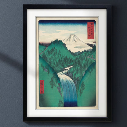 Framed Japanese-style art print depicting a mountain landscape with a waterfall, shown against a plain white background.