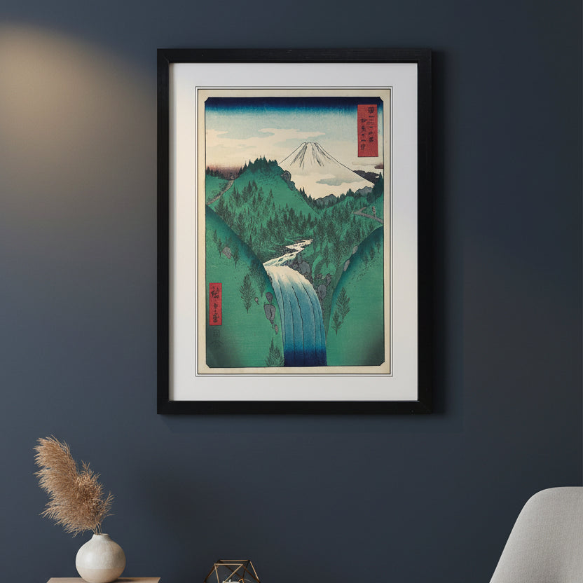 Framed Japanese-style art print depicting a mountain landscape with a waterfall, shown against a plain white background.