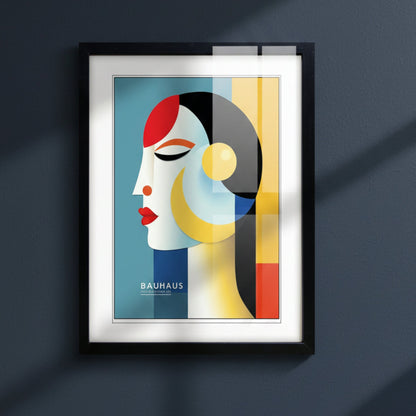 A framed Bauhaus art print featuring a stylized woman's profile in geometric colors, enclosed in a black frame with a white mat on a light gray background.