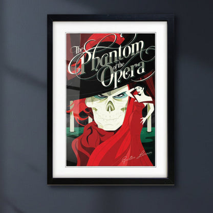 A framed art print of 'The Phantom of the Opera' featuring a stylized illustration of the Phantom skull in a black suit and red cape, with a woman in a red dress in the background, presented in a black frame with a white mat.