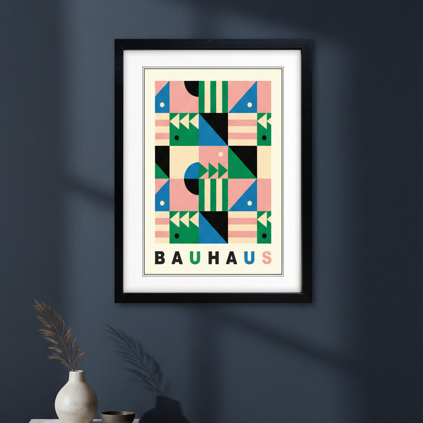 A framed Bauhaus art print featuring a colorful geometric pattern with the word 'BAUHAUS' at the bottom, enclosed in a black frame against a white background.