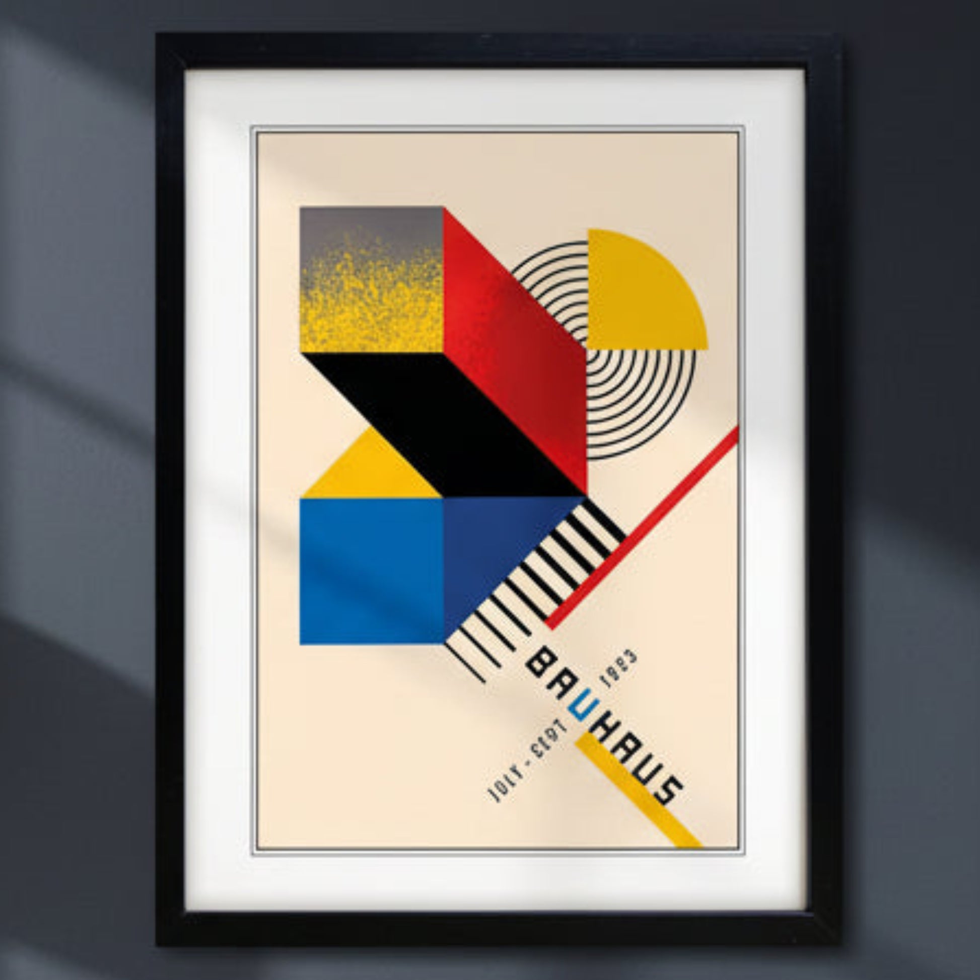 Framed Bauhaus art print featuring a geometric abstract design in red, yellow, blue, black, and beige, with the text 'BAUHAUS' and dates '1913 - 1929' in a minimalist style.