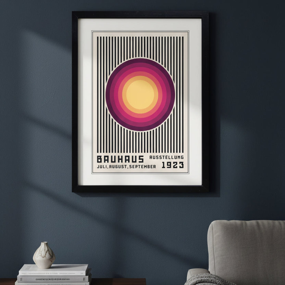 A framed Bauhaus art print featuring a retro geometric design with concentric circles in yellow, orange, pink, and purple over a black and white striped background, enclosed in a black frame.