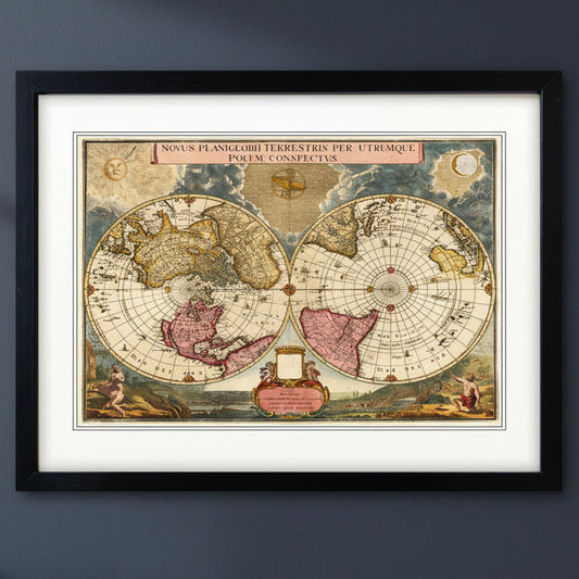 Antique reproduction world atlas map in black frame with white mount on a blu wall with natural lighting 