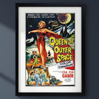 A framed vintage movie poster for 'Queen of Outer Space' with a black frame and white mat, shown against a plain dark blue background.