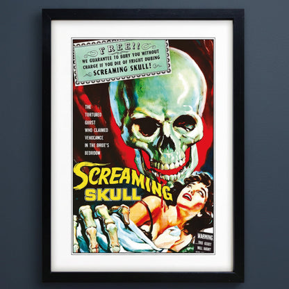 A framed vintage horror movie poster for 'Screaming Skull' with a large green skull, a screaming woman, and bold yellow title text, shown in a black frame with white matting on a grey background.