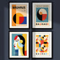 Set of four framed Bauhaus art prints arranged in a 2x2 grid on a white background. Each print features a different abstract geometric design in the classic Bauhaus style, with black frames and white mats.