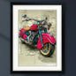 Framed wall art featuring a stylized illustration of a pink and teal motorcycle over a beige blueprint-style background, shown in a black frame with white matting.