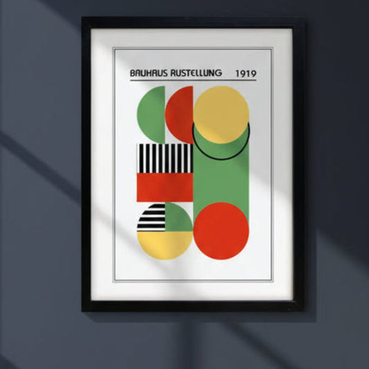 A framed Bauhaus art print featuring a mid-century modern geometric design with overlapping circles, rectangles, and stripes in green, red, yellow, black, and white, enclosed in a black frame.
