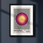 A framed Bauhaus-style art print hanging on a dark gray wall, featuring a central circular motif in yellow, pink, and purple over black vertical stripes, with the text 'BAUHAUS AUSSTELLUNG JULI, AUGUST, SEPTEMBER 1923' at the bottom. The black framed Print is on a dark blue background or wall with natural light.