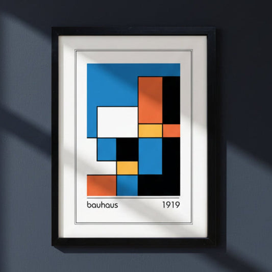 Framed Bauhaus 1919 abstract geometric art print featuring a grid of blue, orange, yellow, black, and white blocks, presented in a black frame with a white mat.