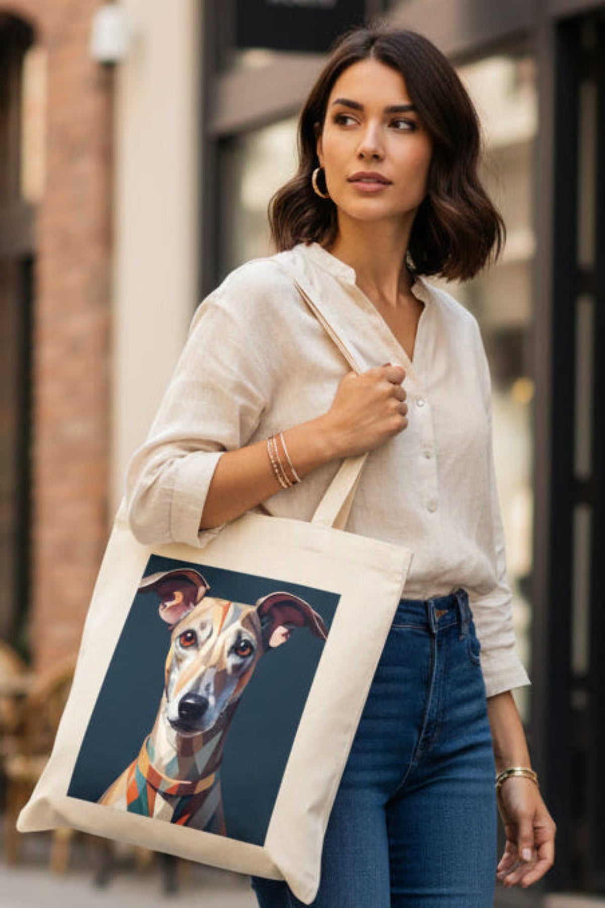 A cream-colored canvas tote bag featuring a stylized geometric art print of an Italian Greyhound dog on the front, set against a plain white background.