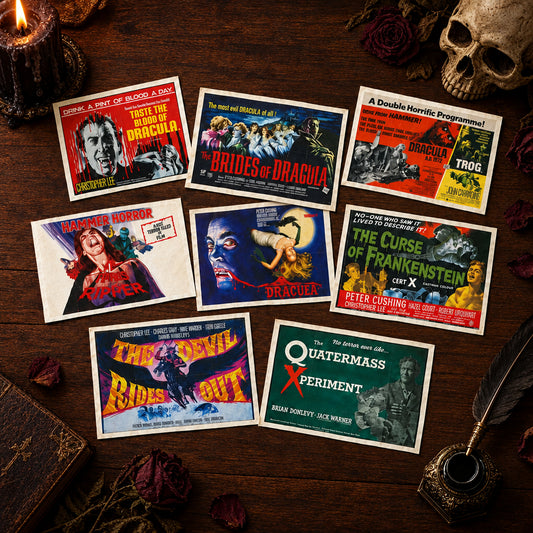 A collection of 8 hammer horror style vintage film posters as postcards displayed on a dark wooden table with gothic ornaments surrounding the cards.