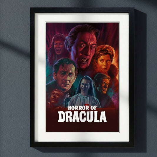 A framed art print of the 'Horror of Dracula' poster, featuring a black frame and white matting. The poster itself displays stylized illustrations of characters from the film with dramatic red, orange, and blue lighting, and the title in bold white letters at the bottom.