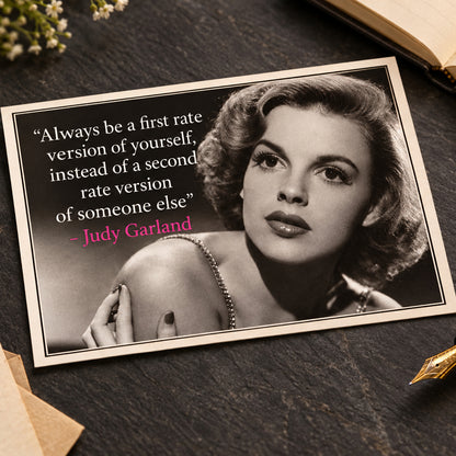 Black and white portrait of Judy Garland with a quote on the left: 'Always be a first rate version of yourself, instead of a second rate version of someone else' in white text, with the name 'Judy Garland' in pink.