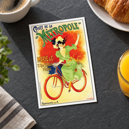 A vintage-style poster print featuring an illustrated woman riding a bicycle with bold decorative text reading "Cycles de la Métropole" and "Marié & C.