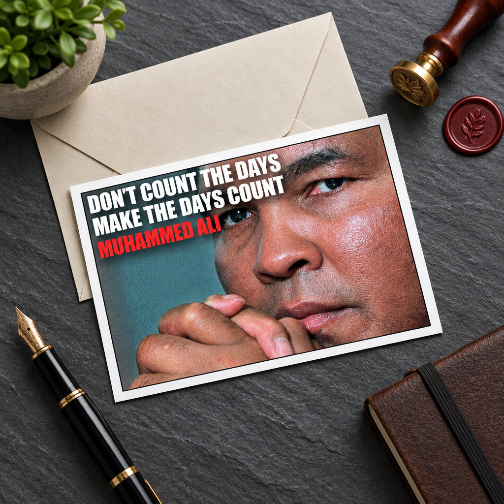 A framed poster featuring a close-up portrait of Muhammad Ali with the text 'DON'T COUNT THE DAYS MAKE THE DAYS COUNT' in white and 'MOHAMMED ALI' in red, shown against a gray gradient background.