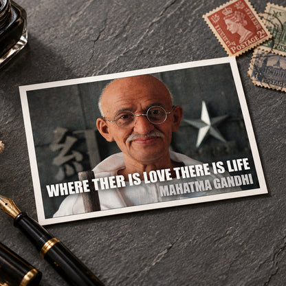 A framed quote print featuring a portrait of Mahatma Gandhi with the text 'WHERE THER IS LOVE THERE IS LIFE' and 'MARATMA GAHDHI' in white lettering, shown against a gray gradient background.