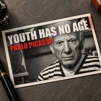 A framed poster print featuring a black-and-white portrait of Pablo Picasso with bold text reading 'YOUTH HAS NO AGE' in white and 'PABLO PICASO' in red, shown against a gray gradient background.