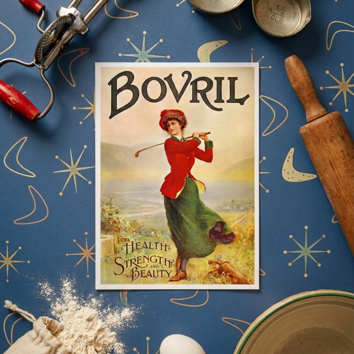 Vintage advertising poster for Bovril featuring a woman in a red jacket and green skirt swinging a golf club on a golf course, with large 'BOVRIL' text at the top and 'For Health, Strength and Beauty' at the bottom.