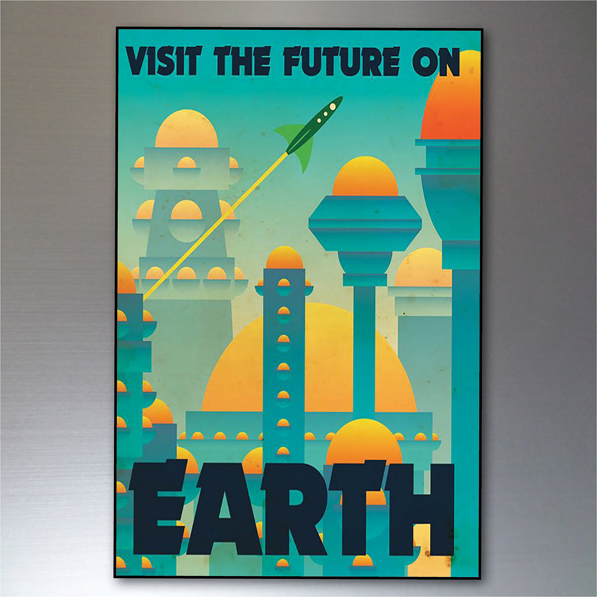 A vertical poster print featuring a stylized retro-futuristic cityscape with domes, towers, and a rocket, with the text 'VISIT THE FUTURE ON EARTH' in dark blue. The artwork is shown hanging against a gray wall.