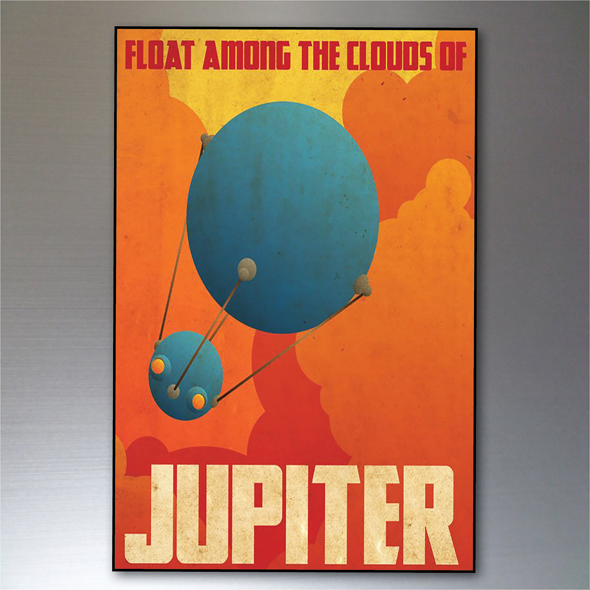 A retro-style poster print featuring a blue planet labeled Jupiter with the text 'FLOAT AMONG THE CLOUDS OF JUPITER' on an orange and red background, shown hanging against a gray wall.