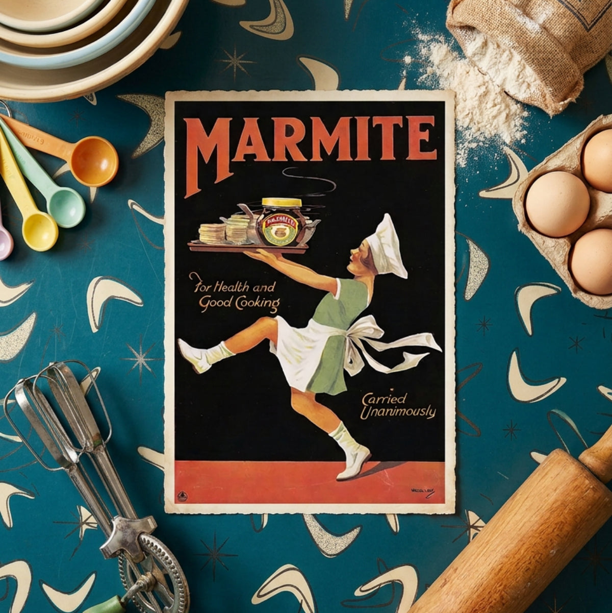 A vintage-style Marmite advertisement print featuring a chef carrying a tray of spreads, styled on a teal patterned surface with baking tools, eggs, flour, and bowls around it.